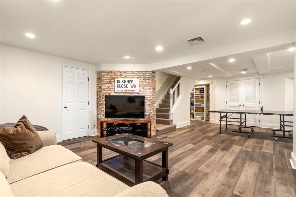 46 Hyslop Road Brookline, MA 02445 - Photo 26 of 33 a living room with furniture and a flat screen tv