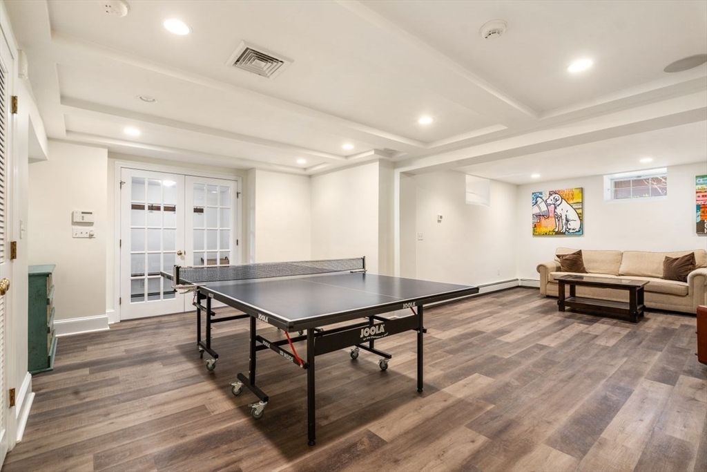 46 Hyslop Road Brookline, MA 02445 - Photo 27 of 33 a living room with a table and a wooden floor