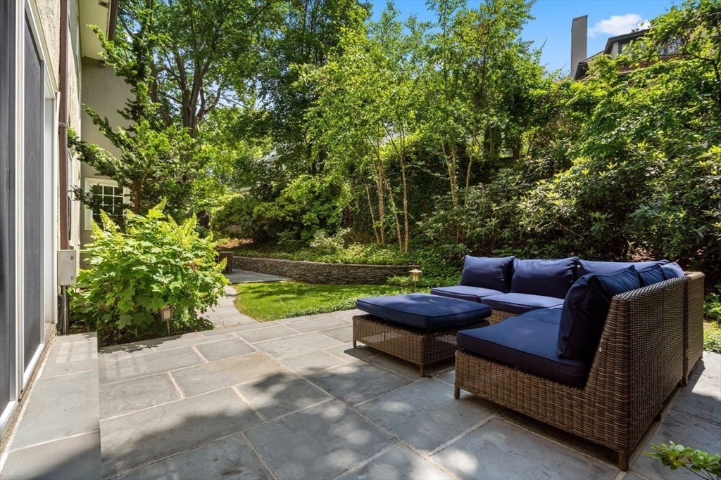 46 Hyslop Road Brookline, MA 02445 - Photo 30 of 33 a backyard of a house with outdoor seating and green space