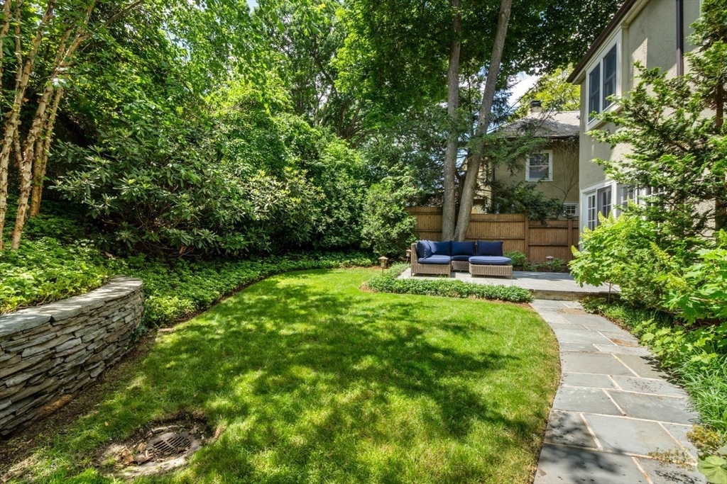 46 Hyslop Road Brookline, MA 02445 - Photo 32 of 33 a view of a patio with table and chairs potted plants and large tree