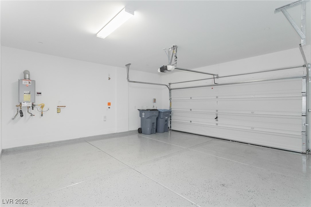 3468 Bradano Lane Henderson, NV 89044 - Photo 16 of 50 Garage featuring baseboards and tankless water heater