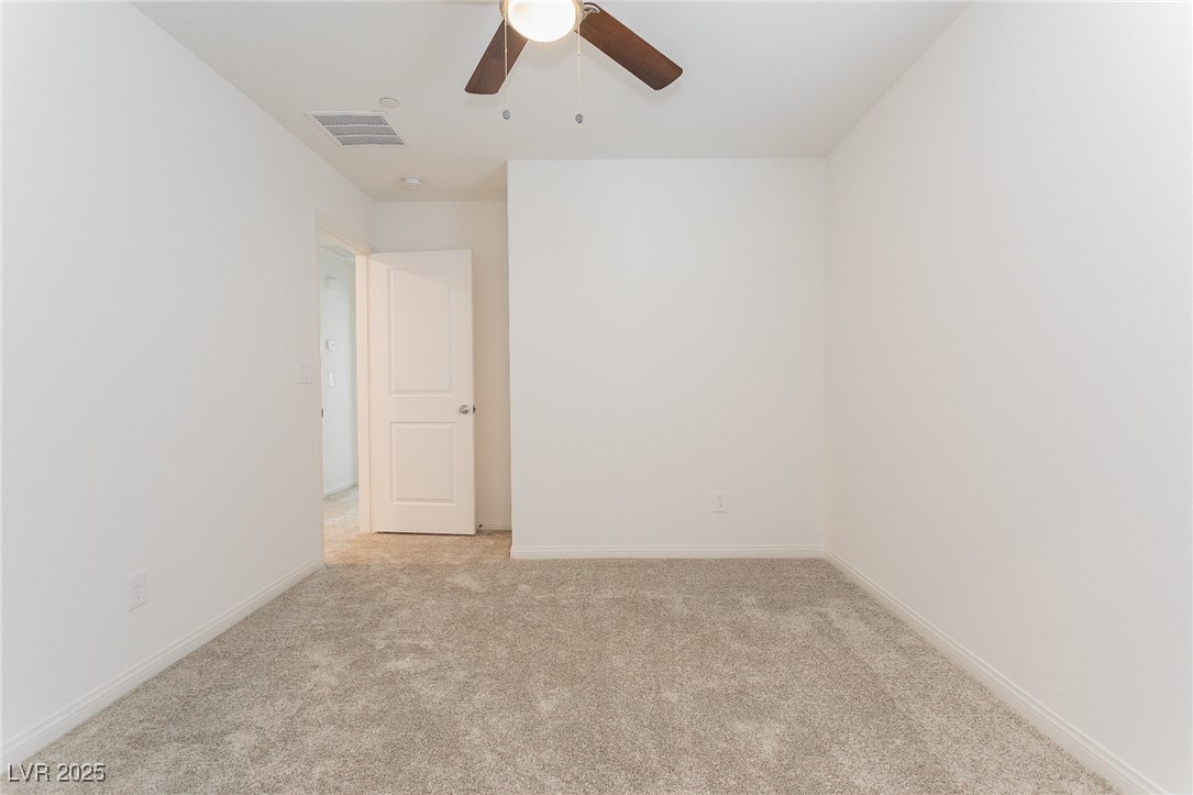 3468 Bradano Lane Henderson, NV 89044 - Photo 31 of 50 Empty room featuring light colored carpet and a ceiling fan