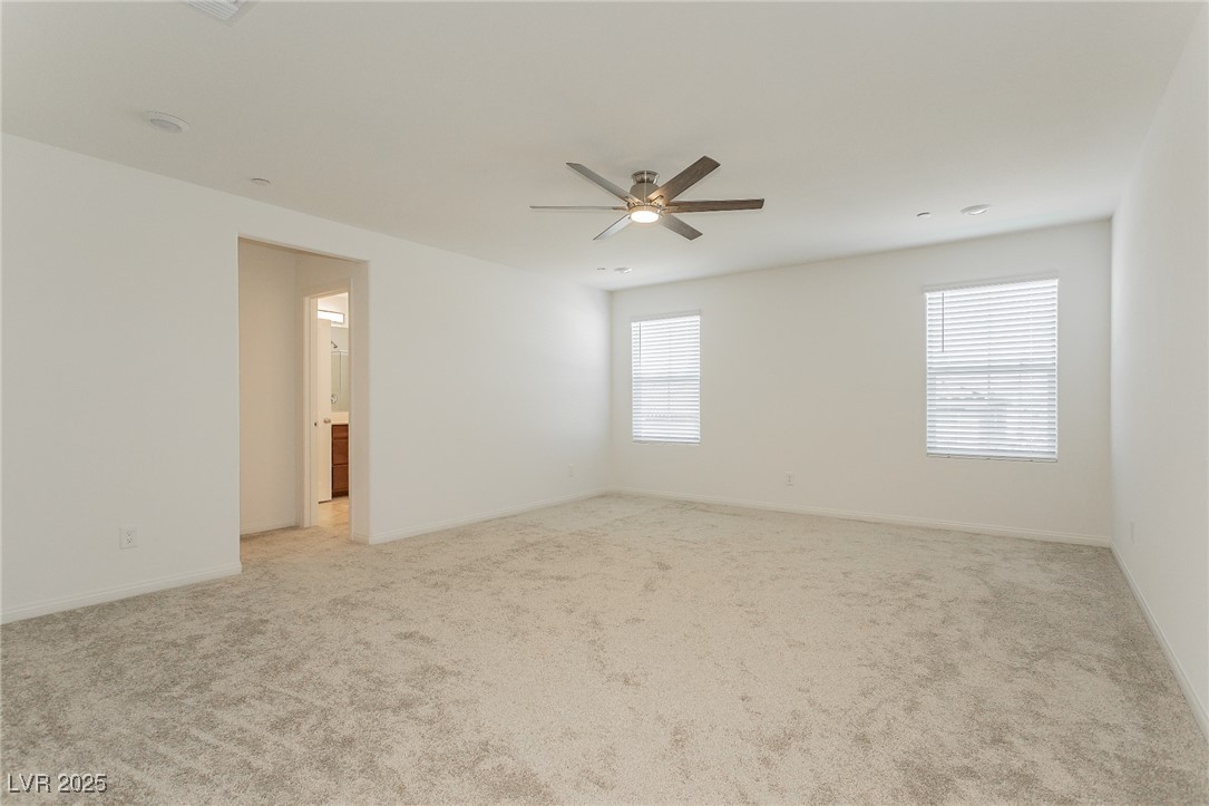 3468 Bradano Lane Henderson, NV 89044 - Photo 32 of 50 Empty room featuring light carpet and ceiling fan