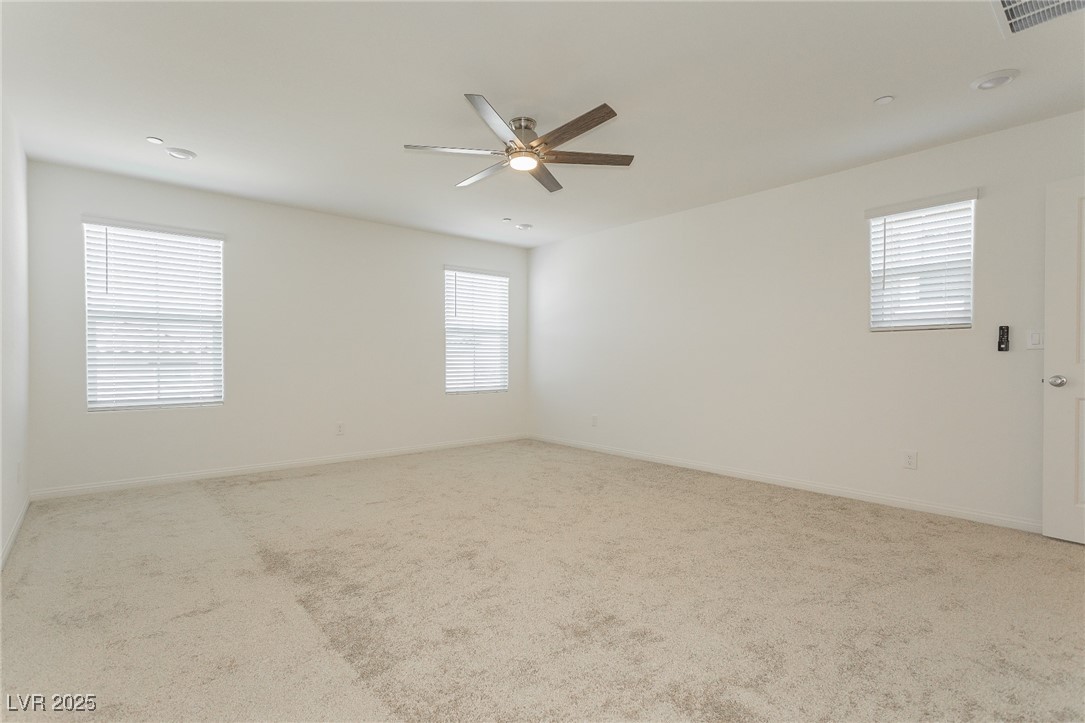 3468 Bradano Lane Henderson, NV 89044 - Photo 33 of 50 Empty room featuring light carpet and ceiling fan