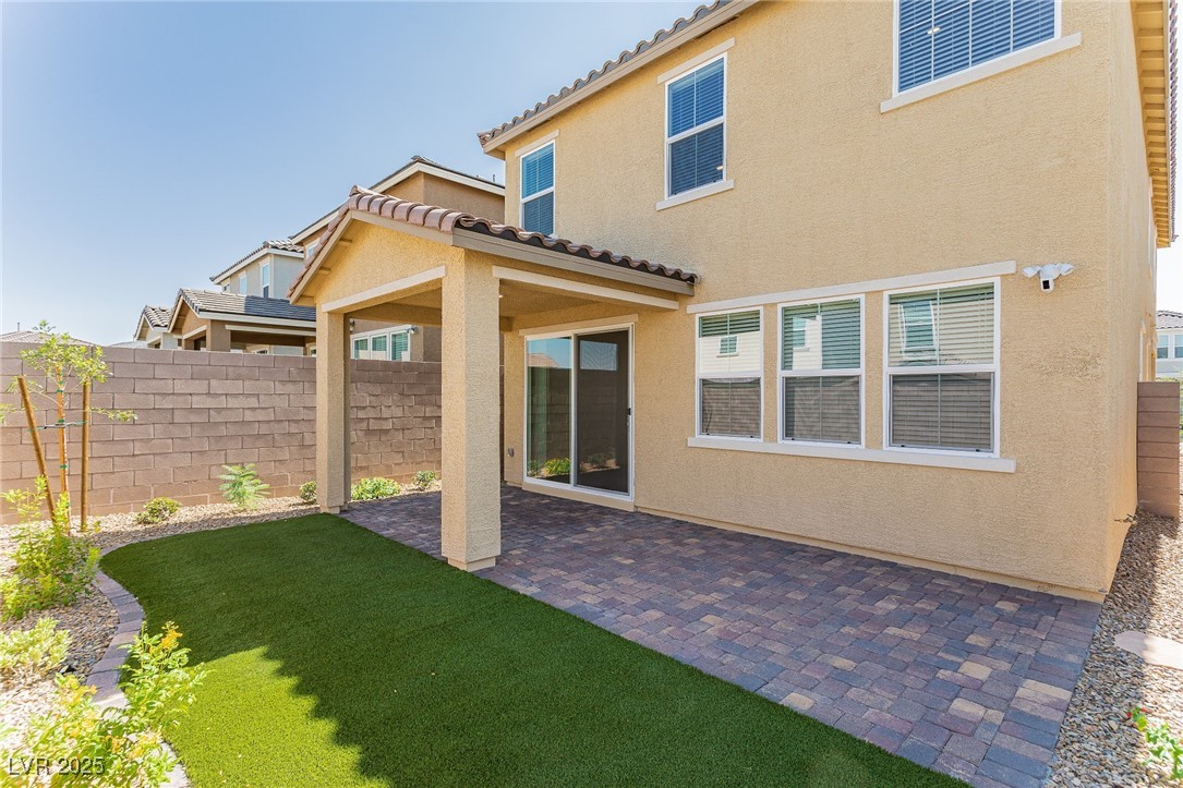 3468 Bradano Lane Henderson, NV 89044 - Photo 41 of 50 Back of house featuring a fenced backyard, a patio, stucco siding, and a tile roof