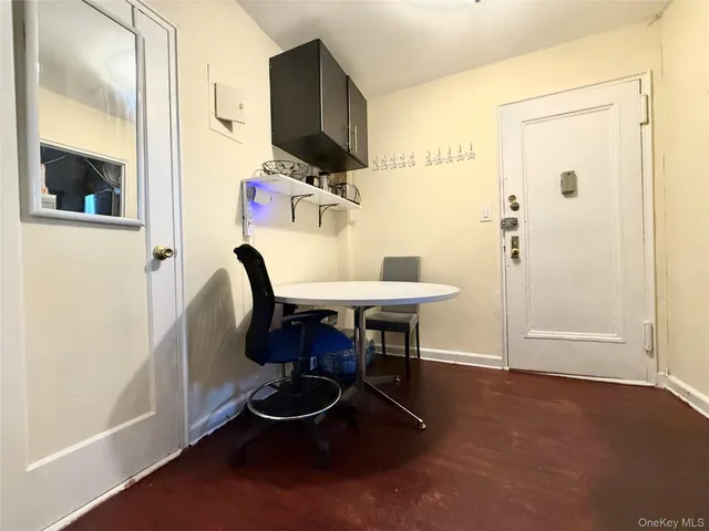 a dining room with furniture and a mirror