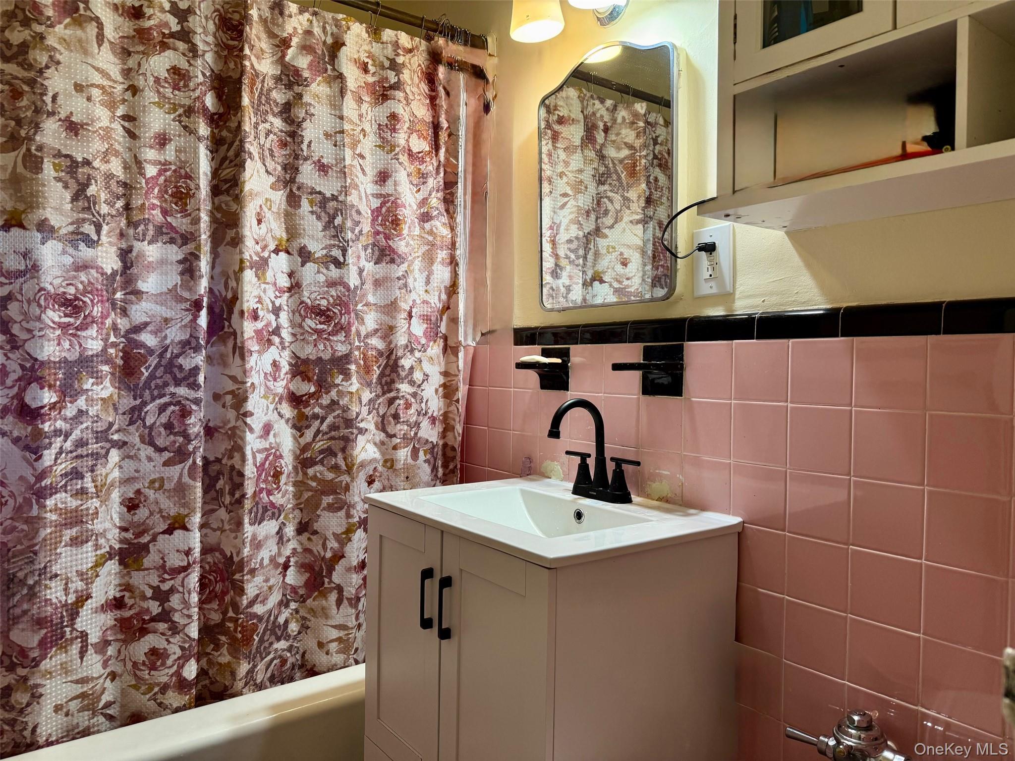 112-25 34th Avenue, Unit 3E Queens, NY 11368 - Photo 15 of 33 a bathroom with a sink and a mirror