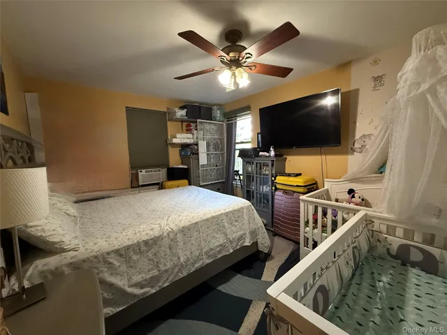 a bedroom with bed and flat screen tv