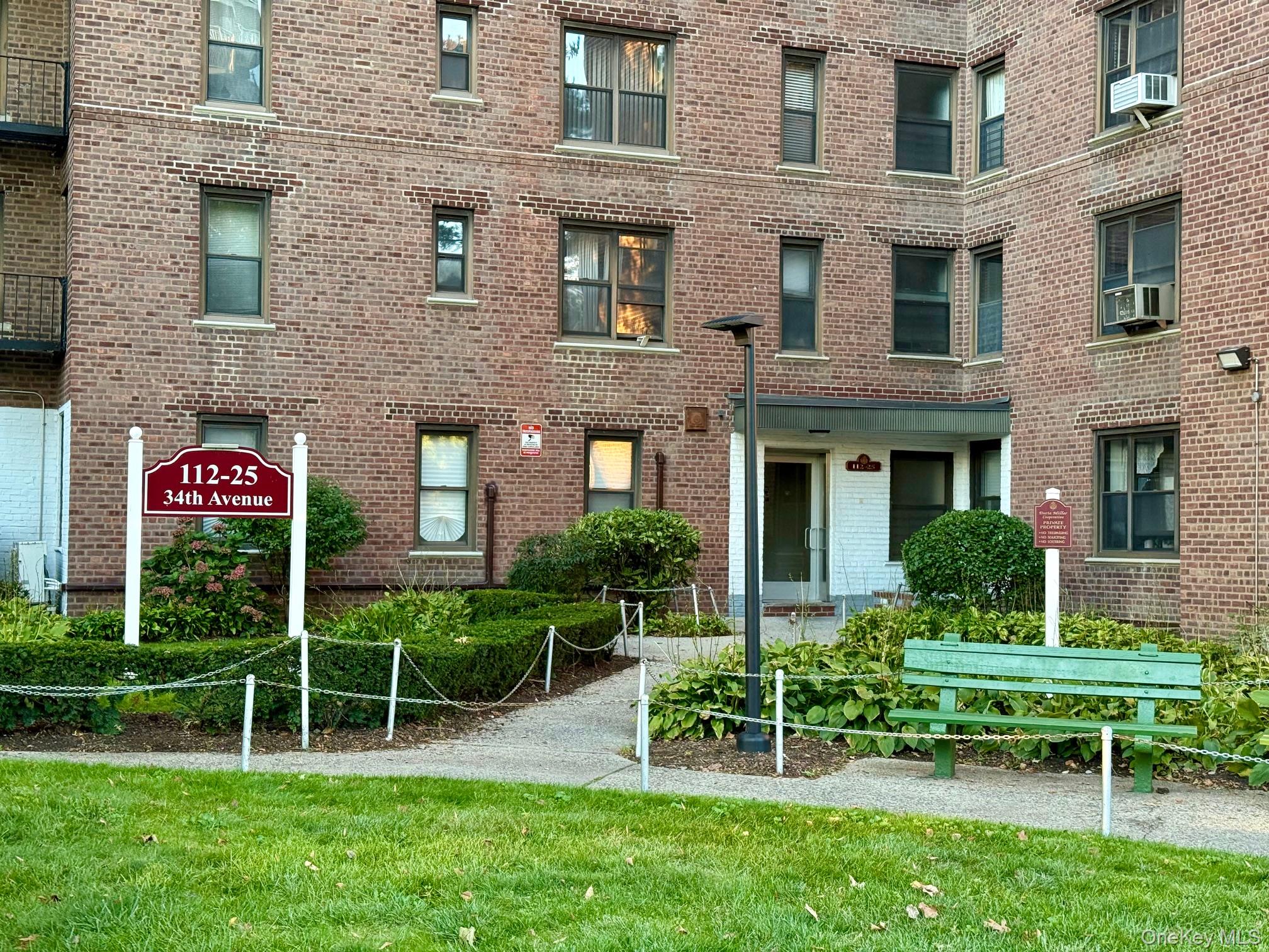 112-25 34th Avenue, Unit 3E Queens, NY 11368 - Photo 26 of 33 a view of a brick house with a yard table and chairs