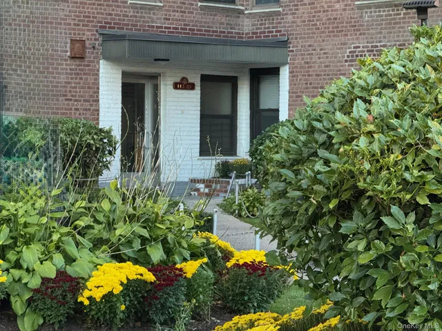 view of a house with a flower garden