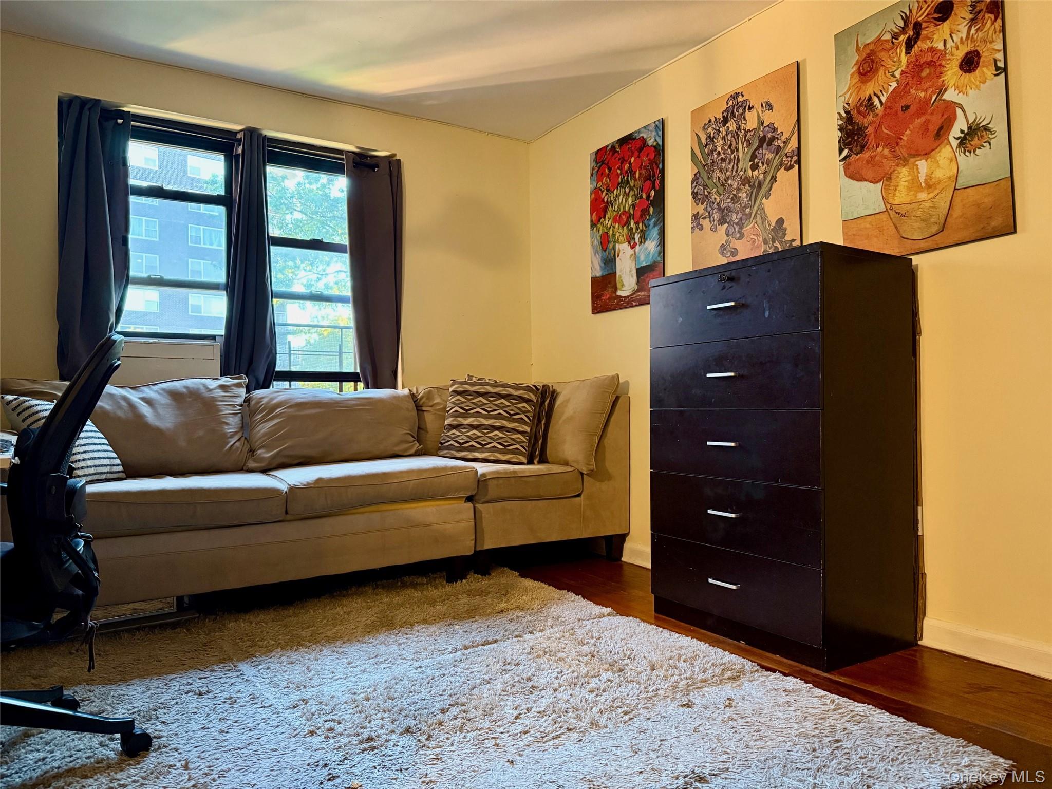 112-25 34th Avenue, Unit 3E Queens, NY 11368 - Photo 8 of 33 a living room with furniture and a rug