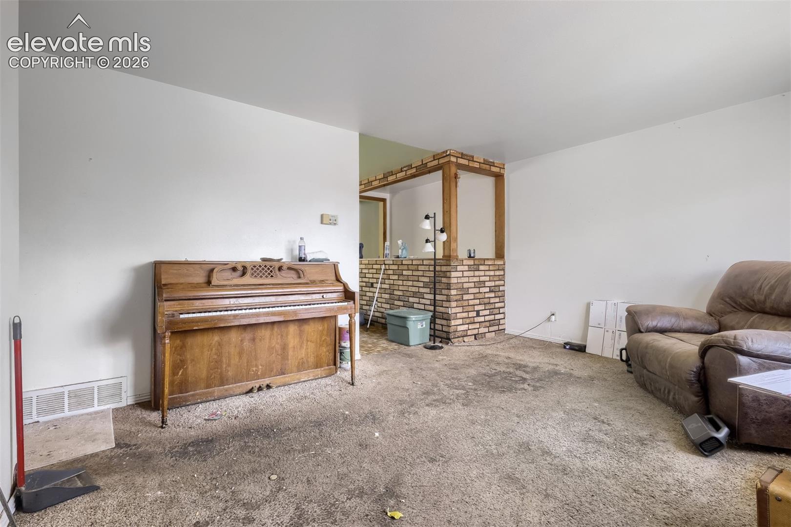 4040 Hollow Road Colorado Springs, CO 80917 - Photo 3 of 11 Another view of living room, piano that will need to taken out by buyer or given away by buyer