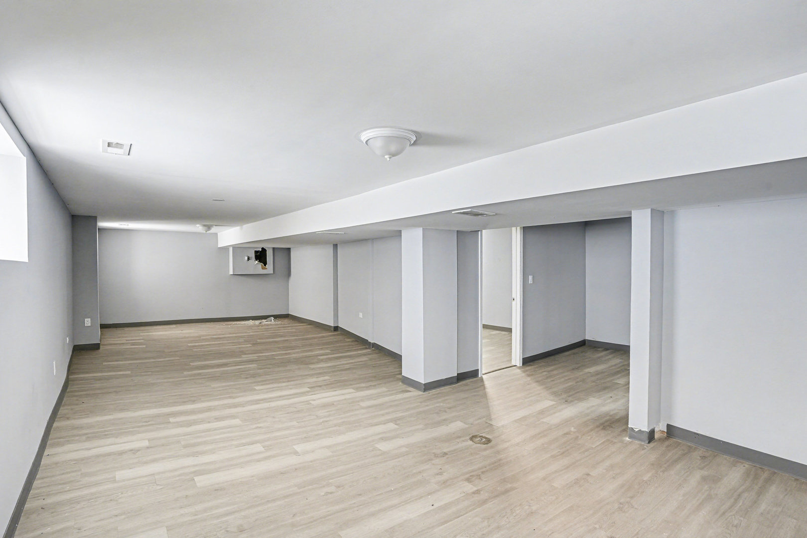 7449 South Bennett Avenue Chicago, IL 60649 - Photo 11 of 15 an empty room with wooden floor and windows