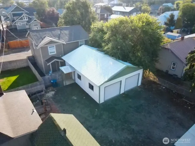 an aerial view of a house with a yard and garage