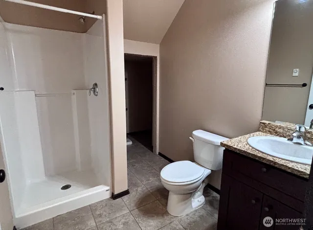 a white toilet sitting next to a bathroom sink