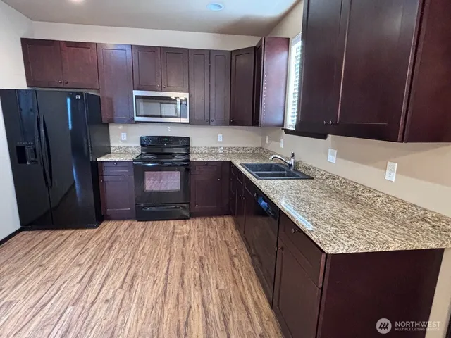 a kitchen with a sink stove and refrigerator