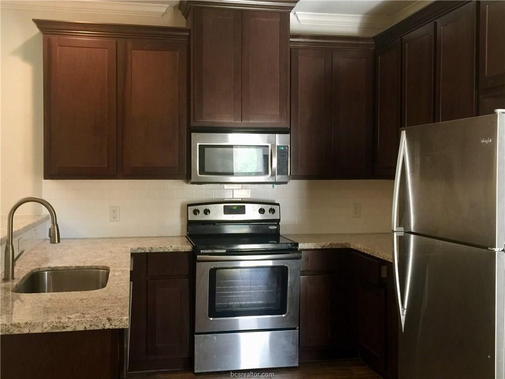 109 Ehlinger Drive Bryan, TX 77801 - Photo 20 of 25 a kitchen with a refrigerator stove and microwave