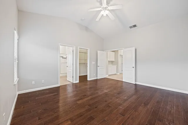 a view of an empty room with wooden floor