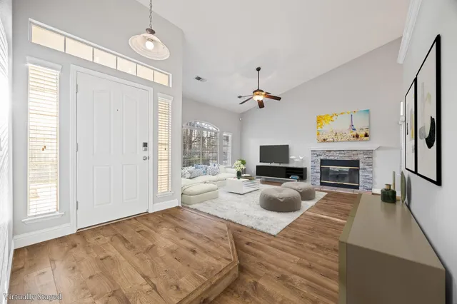 a living room with furniture a fireplace and a flat screen tv