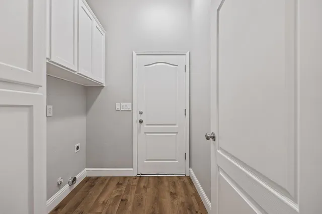 a view of a room with wooden floor