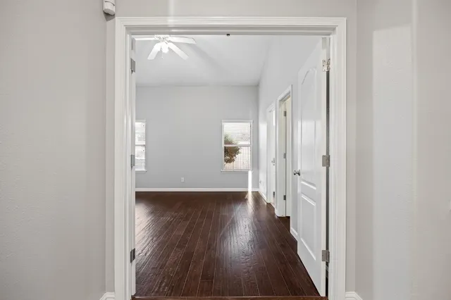 a view of a hallway with wooden floor