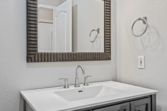 a bathroom with a sink and a mirror