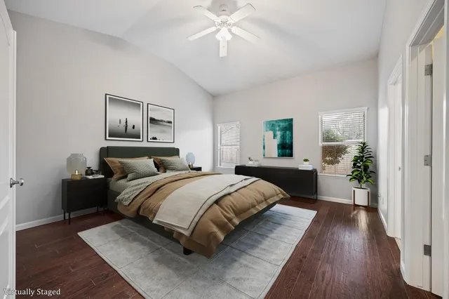 a spacious bedroom with a bed and a chandelier