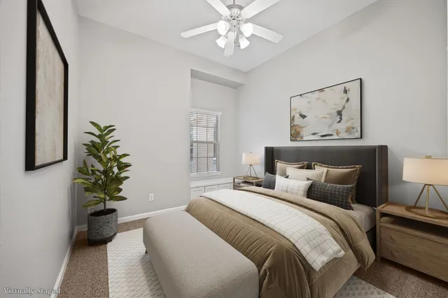 a bedroom with bed and a chandelier