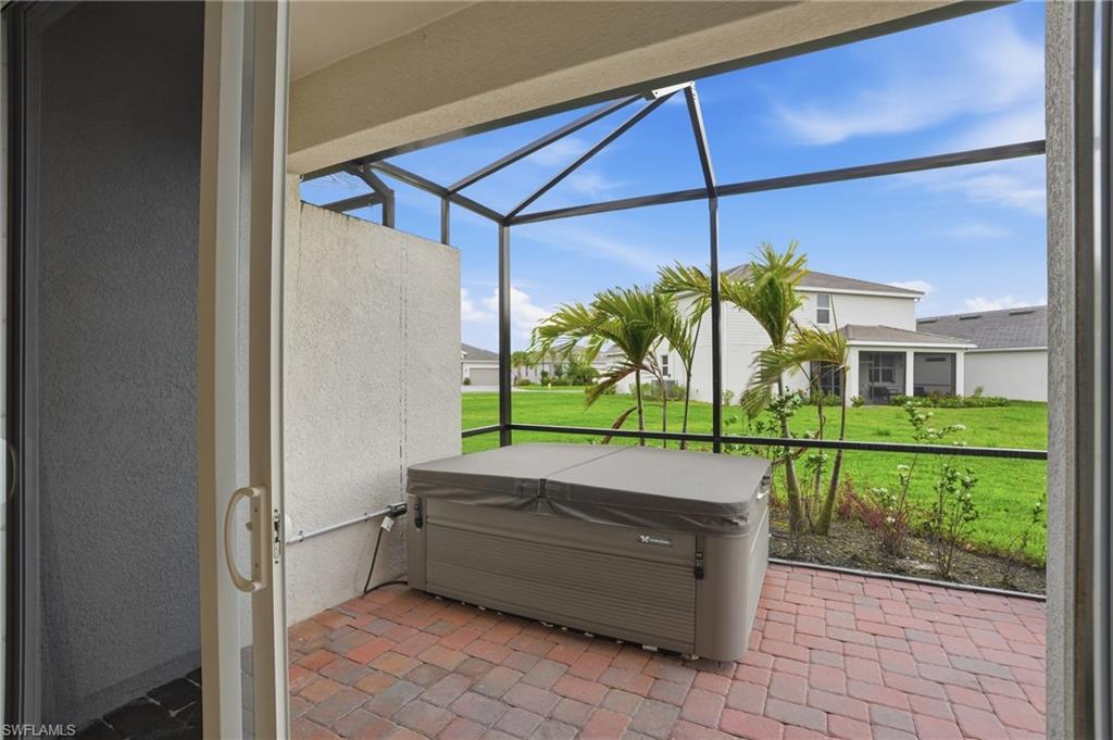 2215 Dragonfruit Way Naples, FL 34120 - Photo 32 of 38 a view of swimming pool with a bench in front of a window