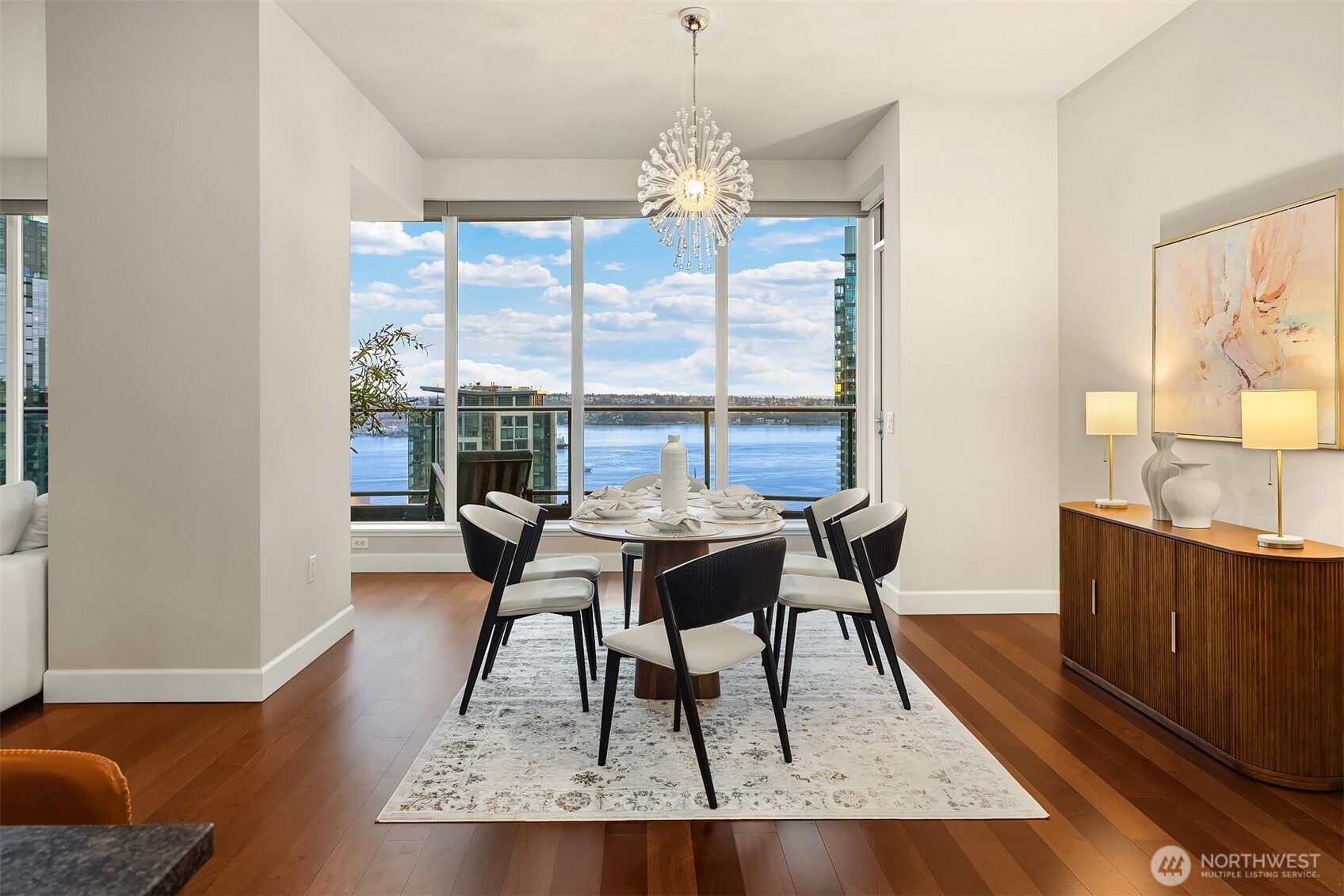 1920 4th Avenue, Unit 2702 Seattle, WA 98101 - Photo 14 of 40 a dining room with wooden floor and a floor to ceiling window