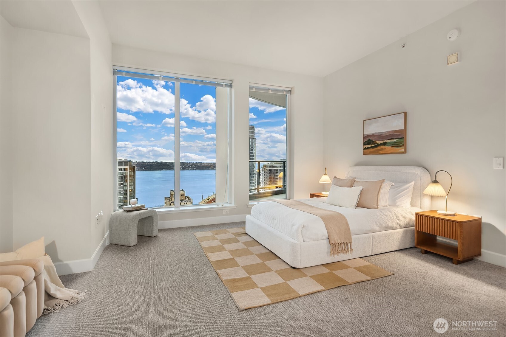1920 4th Avenue, Unit 2702 Seattle, WA 98101 - Photo 22 of 40 a spacious bedroom with a large bed and a large window
