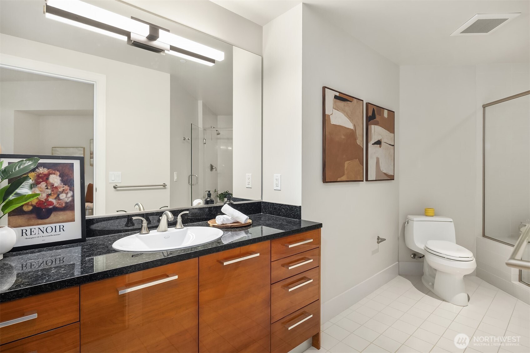1920 4th Avenue, Unit 2702 Seattle, WA 98101 - Photo 26 of 40 a bathroom with a granite countertop sink mirror and toilet