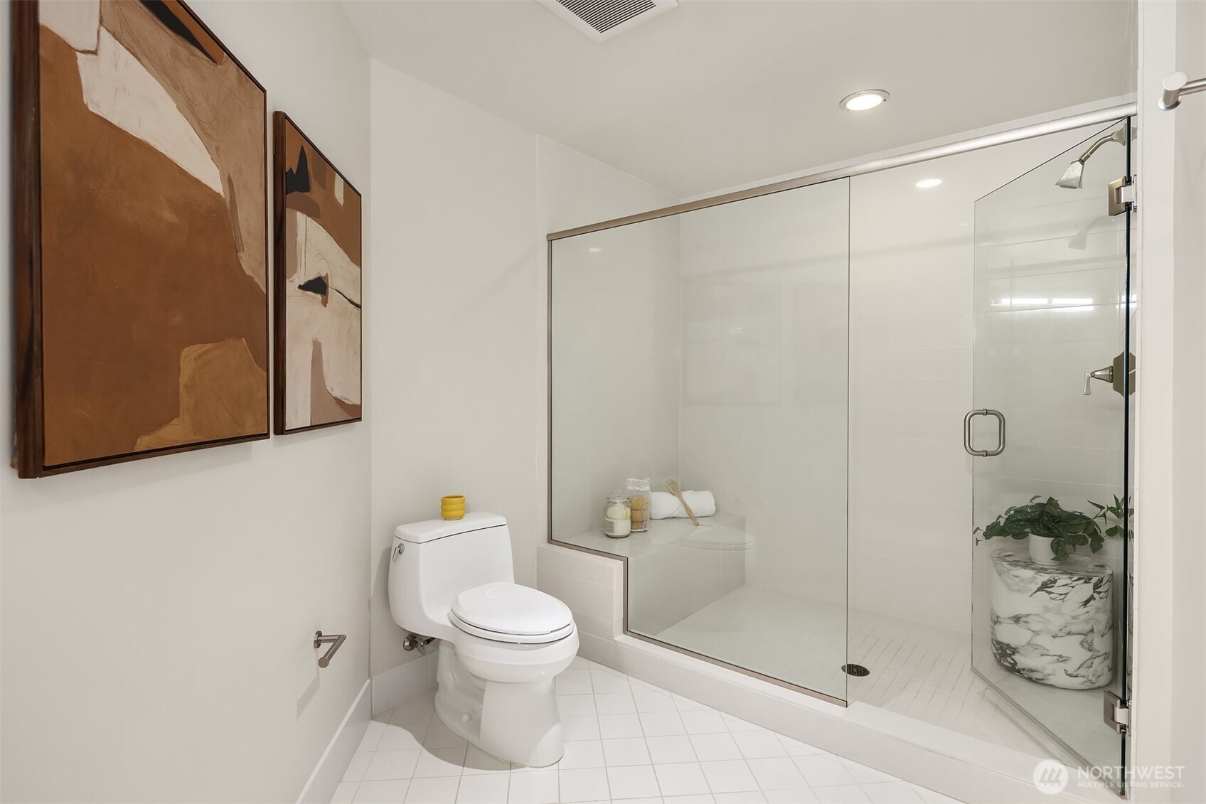 1920 4th Avenue, Unit 2702 Seattle, WA 98101 - Photo 27 of 40 a white toilet sitting next to a bathroom sink