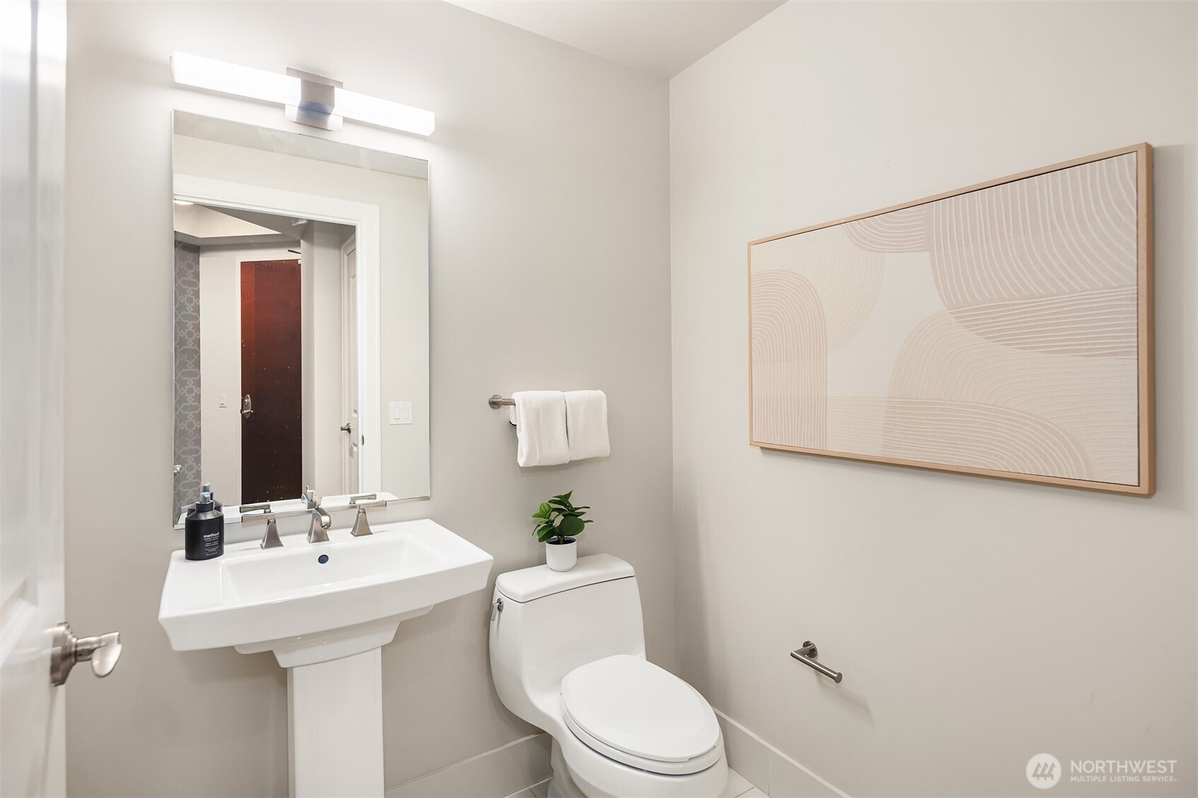 1920 4th Avenue, Unit 2702 Seattle, WA 98101 - Photo 30 of 40 a bathroom with a sink mirror and toilet