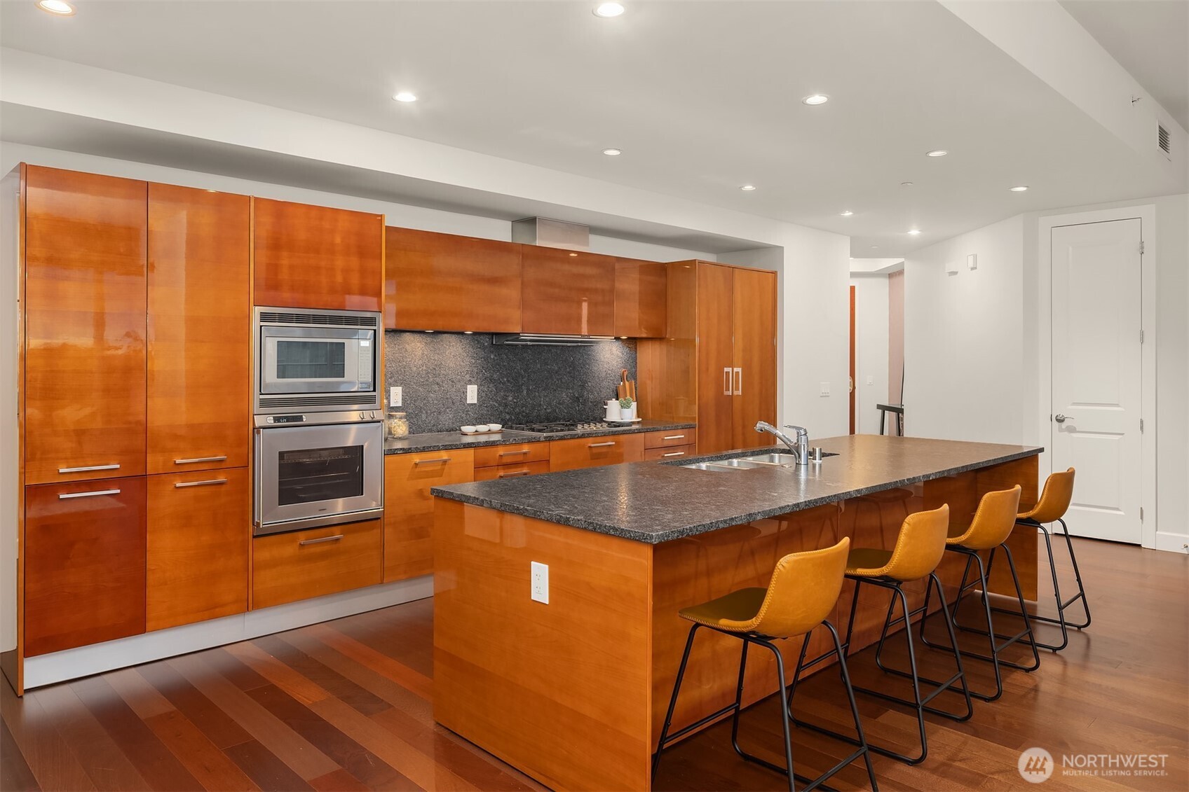 1920 4th Avenue, Unit 2702 Seattle, WA 98101 - Photo 4 of 40 a kitchen with stainless steel appliances granite countertop a stove a sink and a refrigerator
