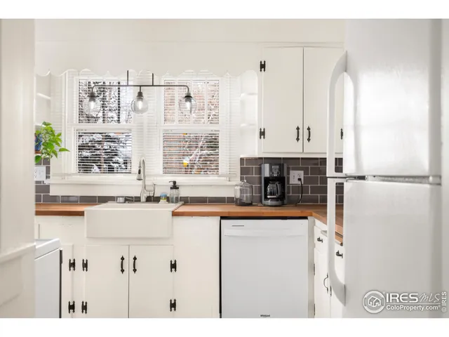 a living room with furniture a flat screen tv and a window