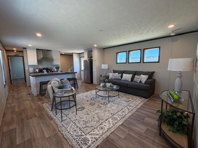 200 West 20th Street, Unit A138 Rifle, CO 81650 - Photo 2 of 7 a living room with furniture and a wooden floor