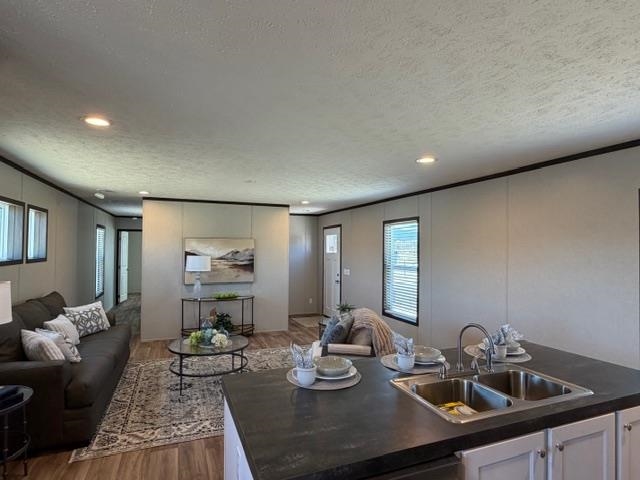 200 West 20th Street, Unit A138 Rifle, CO 81650 - Photo 7 of 7 a kitchen with a sink and living room