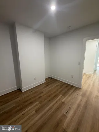 a view of a room with wooden floor