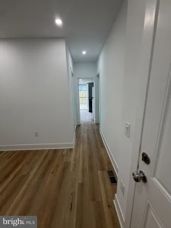 a view of room with wooden floor