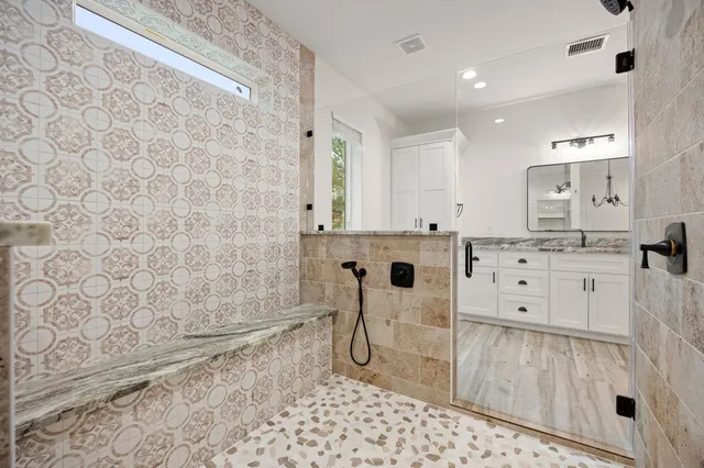 a bathroom with a bathtub sink and mirror