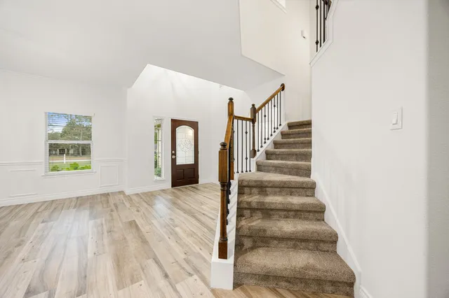 a view of entryway and hall with wooden floor