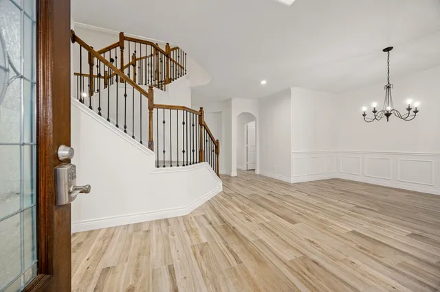 a view of a livingroom with wooden floor and stairs