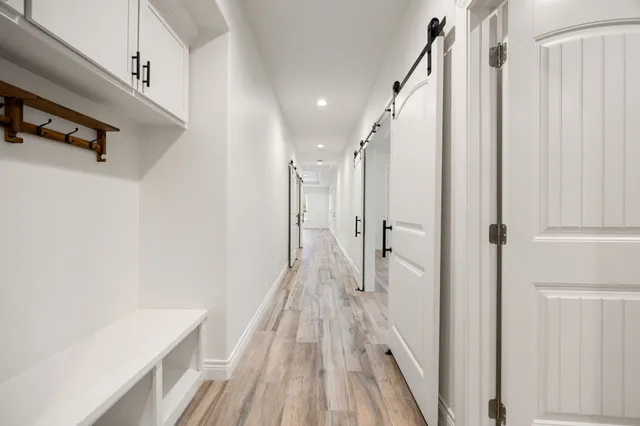 a view of a hallway with wooden floor and staircase