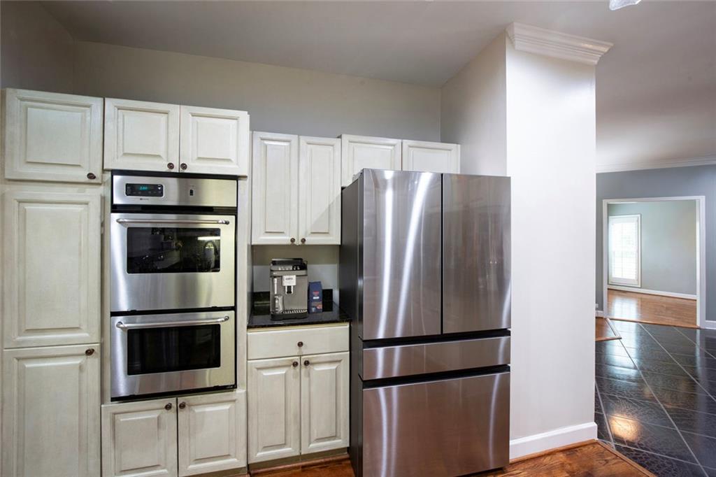 5264 Brooke Ridge Drive Dunwoody, GA 30338 - Photo 12 of 34 a kitchen with stainless steel appliances a refrigerator a microwave and cabinets