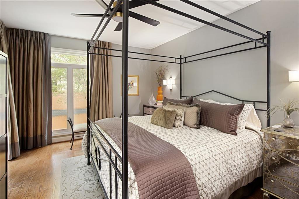 5264 Brooke Ridge Drive Dunwoody, GA 30338 - Photo 15 of 34 a bedroom with a bed and a chandelier