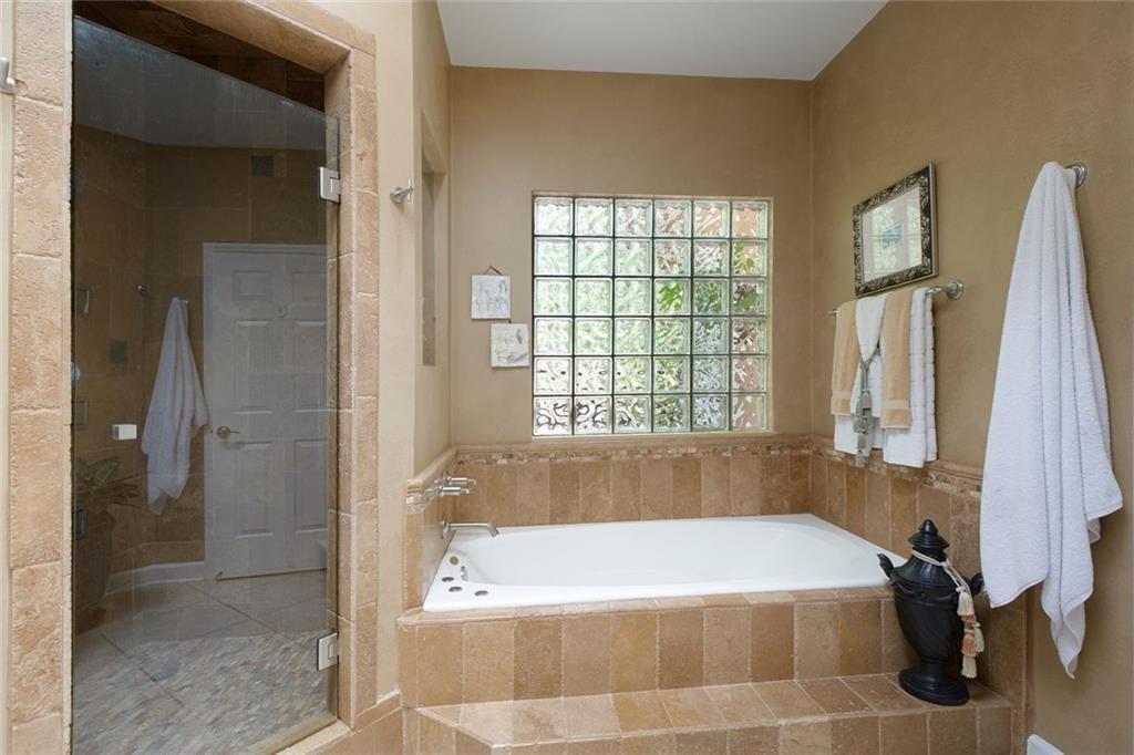 5264 Brooke Ridge Drive Dunwoody, GA 30338 - Photo 19 of 34 a bath tub sitting in a bathroom next to a window