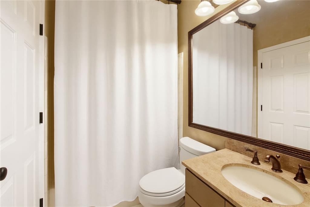 5264 Brooke Ridge Drive Dunwoody, GA 30338 - Photo 21 of 34 a bathroom with a sink toilet and shower