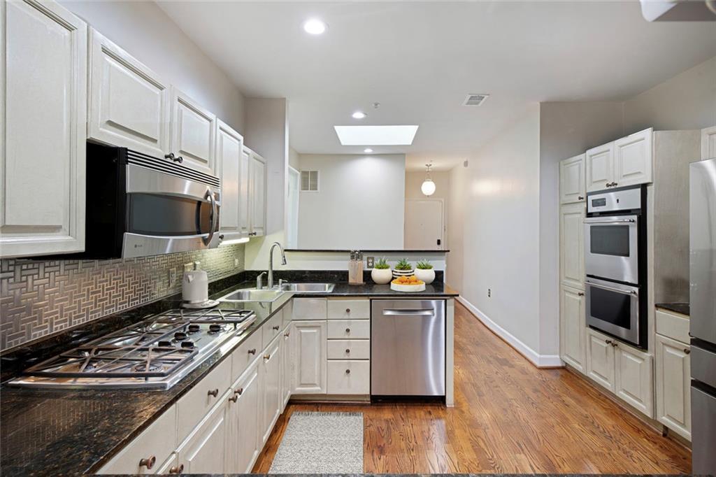 5264 Brooke Ridge Drive Dunwoody, GA 30338 - Photo 9 of 34 a large kitchen with stainless steel appliances granite countertop a stove a sink and a refrigerator