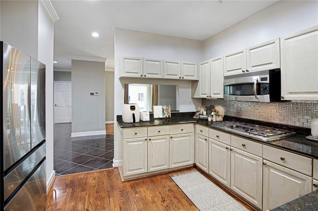 5264 Brooke Ridge Drive Dunwoody, GA 30338 - Photo 10 of 34 a kitchen with granite countertop a sink stainless steel appliances and cabinets